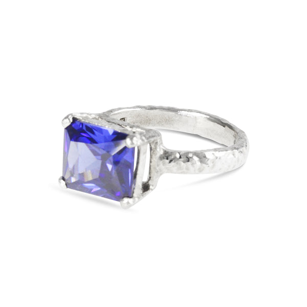 Ring in textured silver set with a blue cubic zirconia. - paul magen