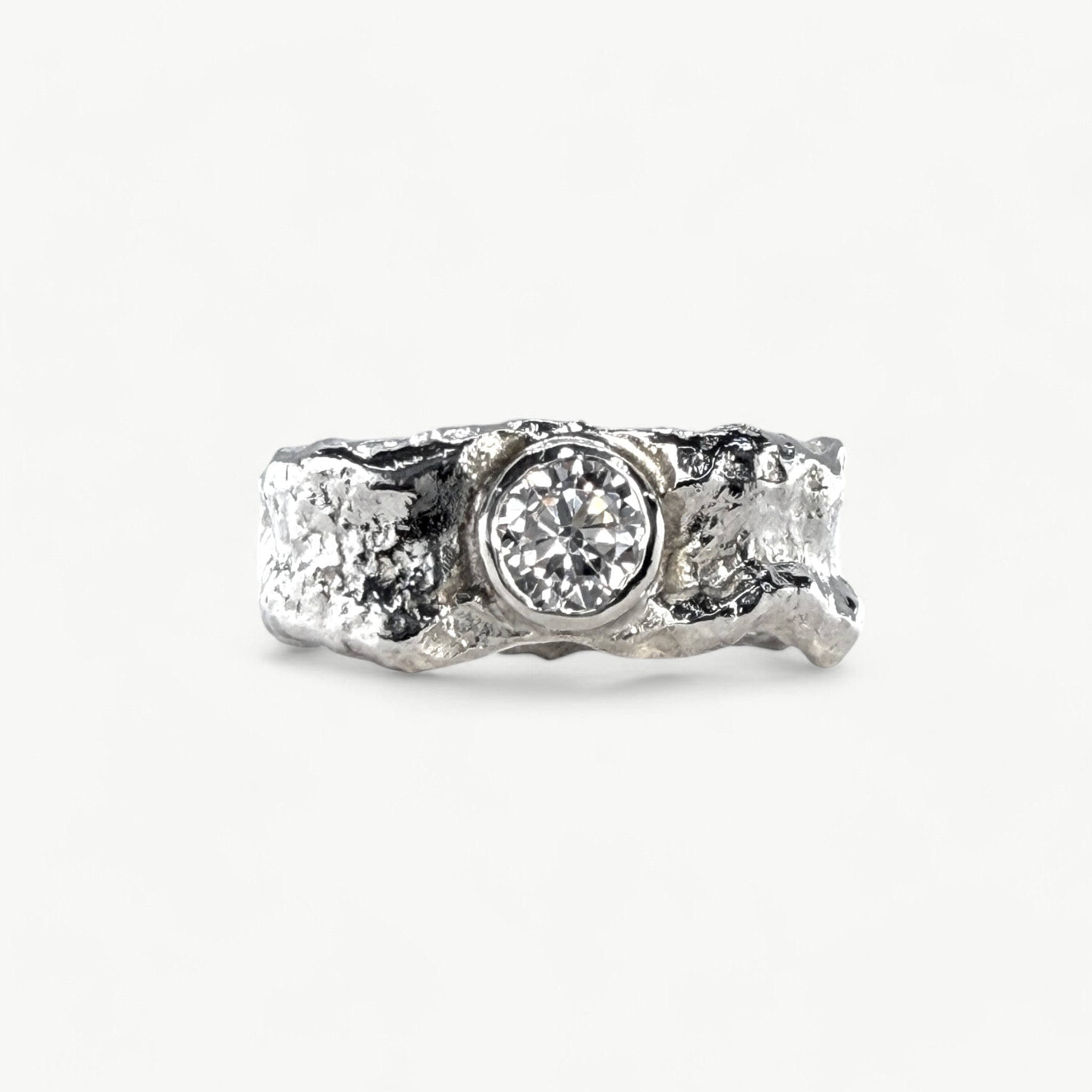 Molten silver ring set with white CZ