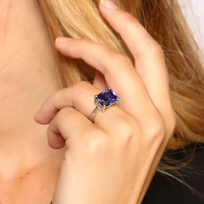 Ring in textured silver set with a blue cubic zirconia. - paul magen